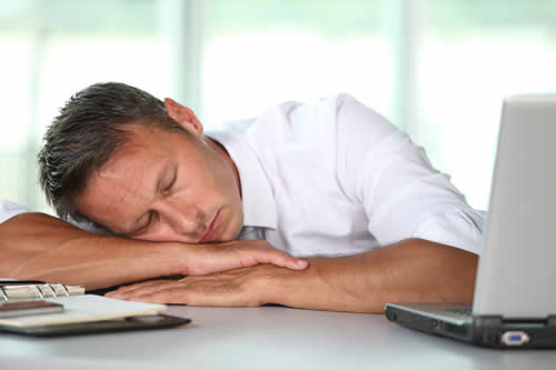 bigstock-Businessman-asleep-on-his-desk-16988432